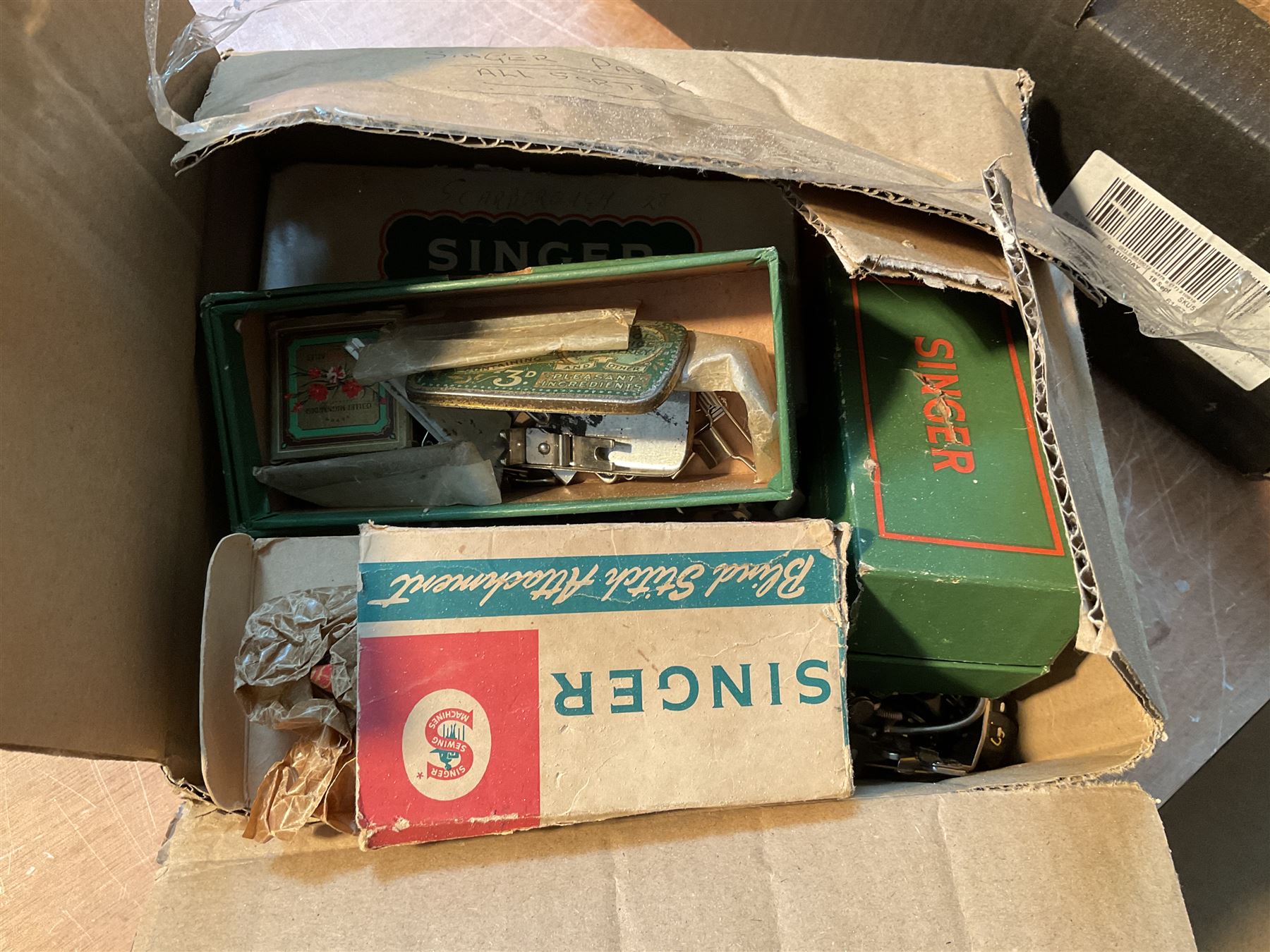 Two Singer sewing machines, model numbers 527 and 457, together with various Singer sewing machine parts, and a selection of sewing related accessories, to include threads, sewing needles, etc.