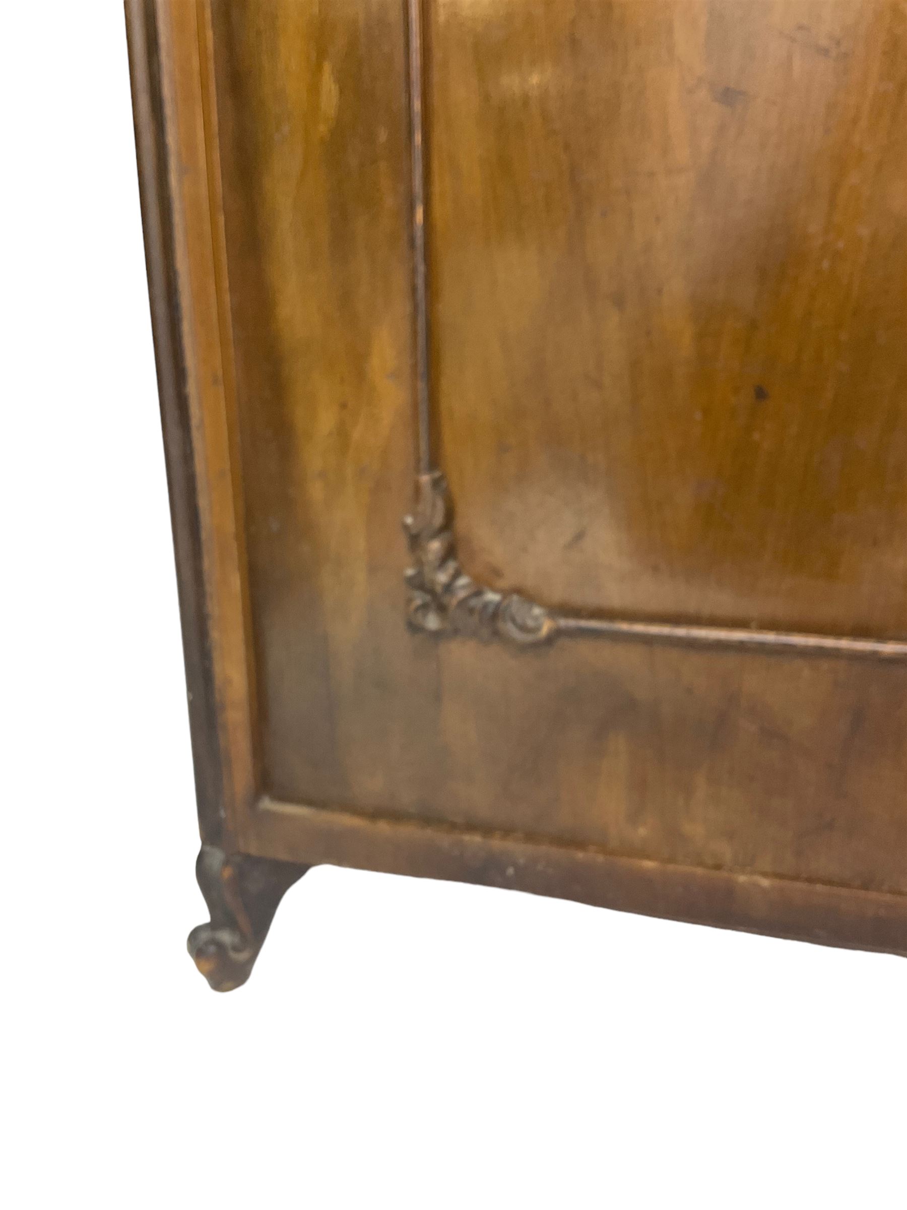 Early 20th century Italian walnut armoire wardrobe, the pierced and scrolling pediment carved with acanthus leaf detail, flanked by two scrolling cartouche with matching corbels below, the two panelled doors with applied carved rinceaux slips, with a central spiral turned upright, enclosing single shelf and hooks, raised on scroll feet