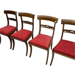Set four Regency rosewood dining chairs, curved cresting rail over foliage scroll carved centre rail, upholstered drop in seats, on sabre front supports