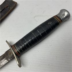  British Private Purchase fighting knife by William Rodgers, Sheffield, the 15cm double edge steel blade with raised medial ridge, stamped on one side of the ricasso WILLIAM RODGERS I CUT MY WAY, the opposing side marked MADE IN SHEFFIELD, ENGLAND, with aluminium crossguard and pommel, stacked leather washers grip and leather scabbard L27.5cm overall; and a crudely made short sword with 32.5cm single edged blade and steel knucklebow hilt with hardwood grip; in cane bound wooden scabbard L45cm overall (2)