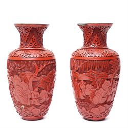 Pair of Chinese late Qing dynasty cinnabar lacquer vases, carved with scenes of figures in a landscape, H25cm (2)