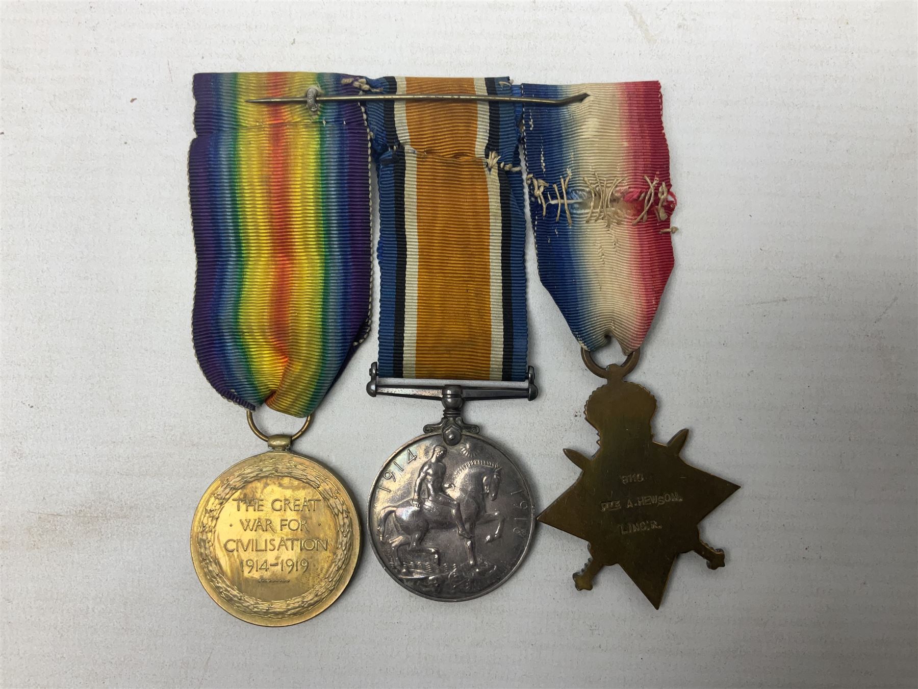 WW1 group of three medals comprising British War Medal, 1914-15 Star and Victory Medal awarded to 8110 Pte. A. Hewson Linc. R.; with ribbons