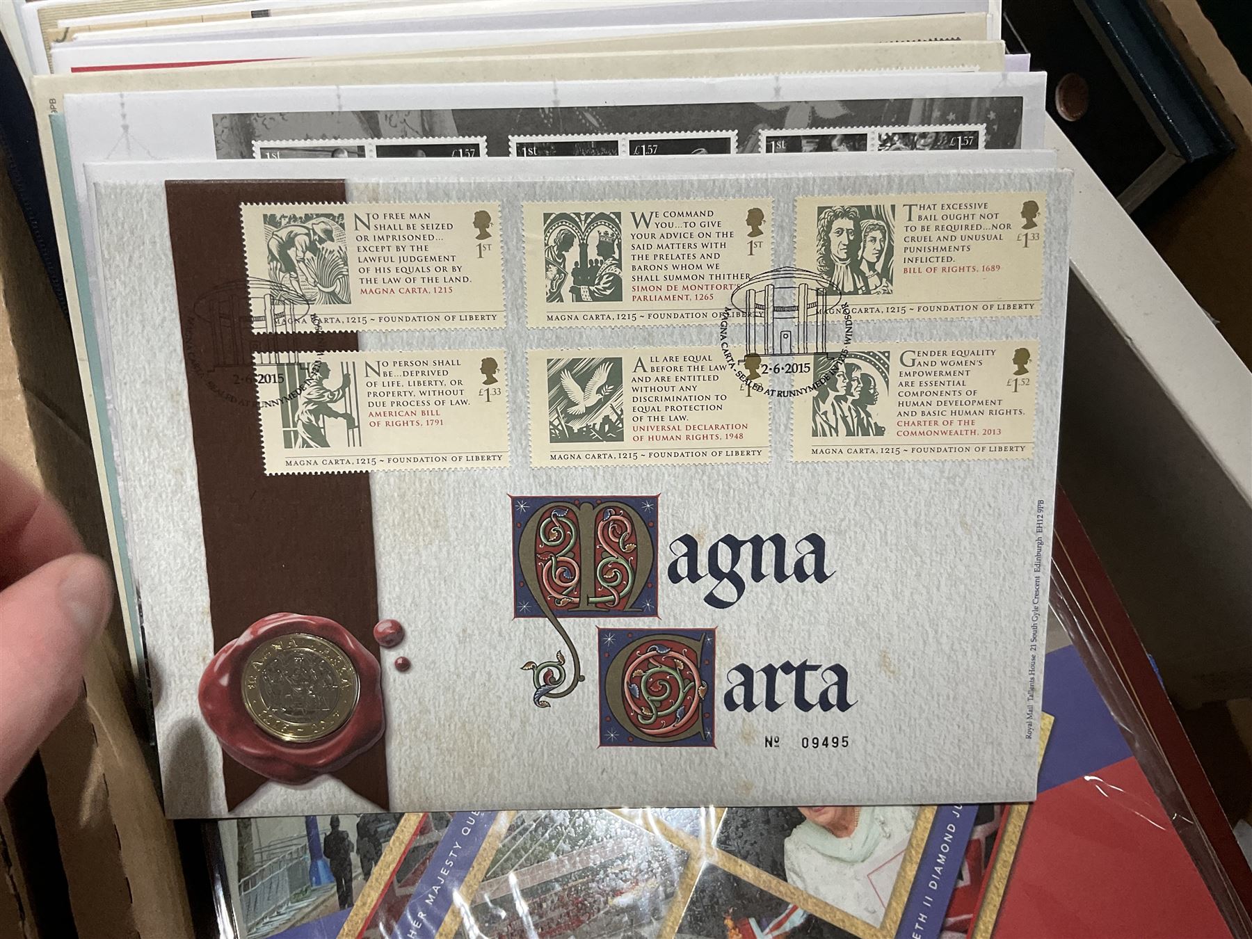 Approximately one hundred and fifteen Royal Mint coin covers, in two ring binder folders and loose, together with approximately 53 grams of Great British pre-1920 and approximately 68 grams of Great British pre-1947 silver threepence coins, and a small quantity of further pre-decimal coins