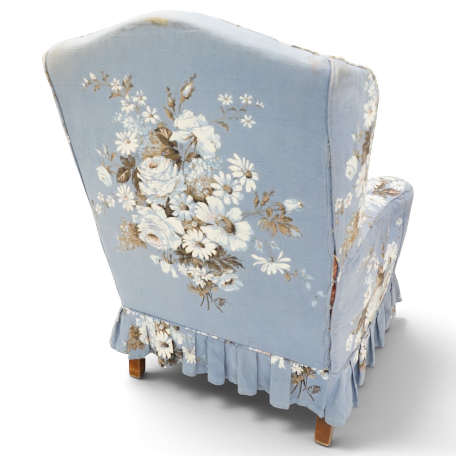 Pair of Queen Anne wingback armchairs, high back over out-swept arms, raised on ball-and-claw feet, upholstered in sky-blue ground floral chintz loose upholstery with pleated skirt and squab cushion