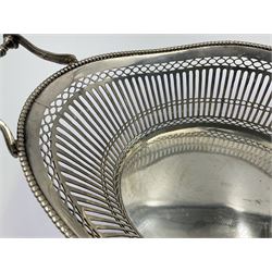 Early 20th century Dutch silver basket, of oval form with pierced sides, beaded rim, and twin handles, marked with Lion Passant for 2nd standard purity and date letter for 1910, other marks worn and indistinct, including handles H8.5cm L25.5cm