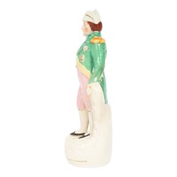 Rare mid 19th century Staffordshire pottery figure of Admiral Lord Nelson, modelled standing in uniform with green tunic, beside anchor, H27cm