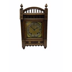A late 19th century Winterhalder & Hofmeier quarter striking eight-day mantle clock striking the hours and quarters on two coiled gongs, with a recoil escapement and double quarter rack strike, in an aesthetic movement oak case with incised carving, trefoil frieze, raised turned finials and baluster pediment, case door with sound fret, square brass dial, silvered chapter ring with roman numerals, minute track and half hour markers, steel Fleur de Lys hands and cherub face spandrels, dial inscribed “Burrell Sheffield”.
With pendulum & Key.
