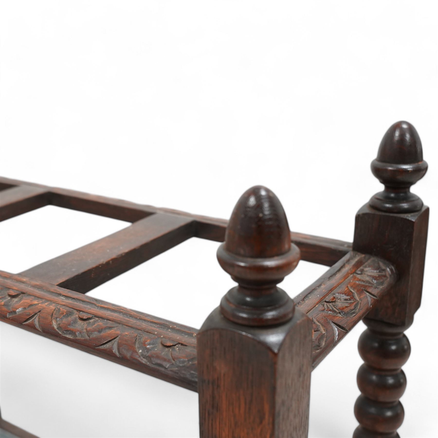Victorian carved oak stick stand, three divisions within lunette carved frame, on bobbin turned supports united by carved stretchers, with drip tray 
