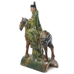 Chinese Ming dynasty Sancai Glazed Roof Tile, modelled as a dignitary on horseback, dressed in a long robe with voluminous folds, wearing an official's cap, upon a half cylinder tile, H40cm