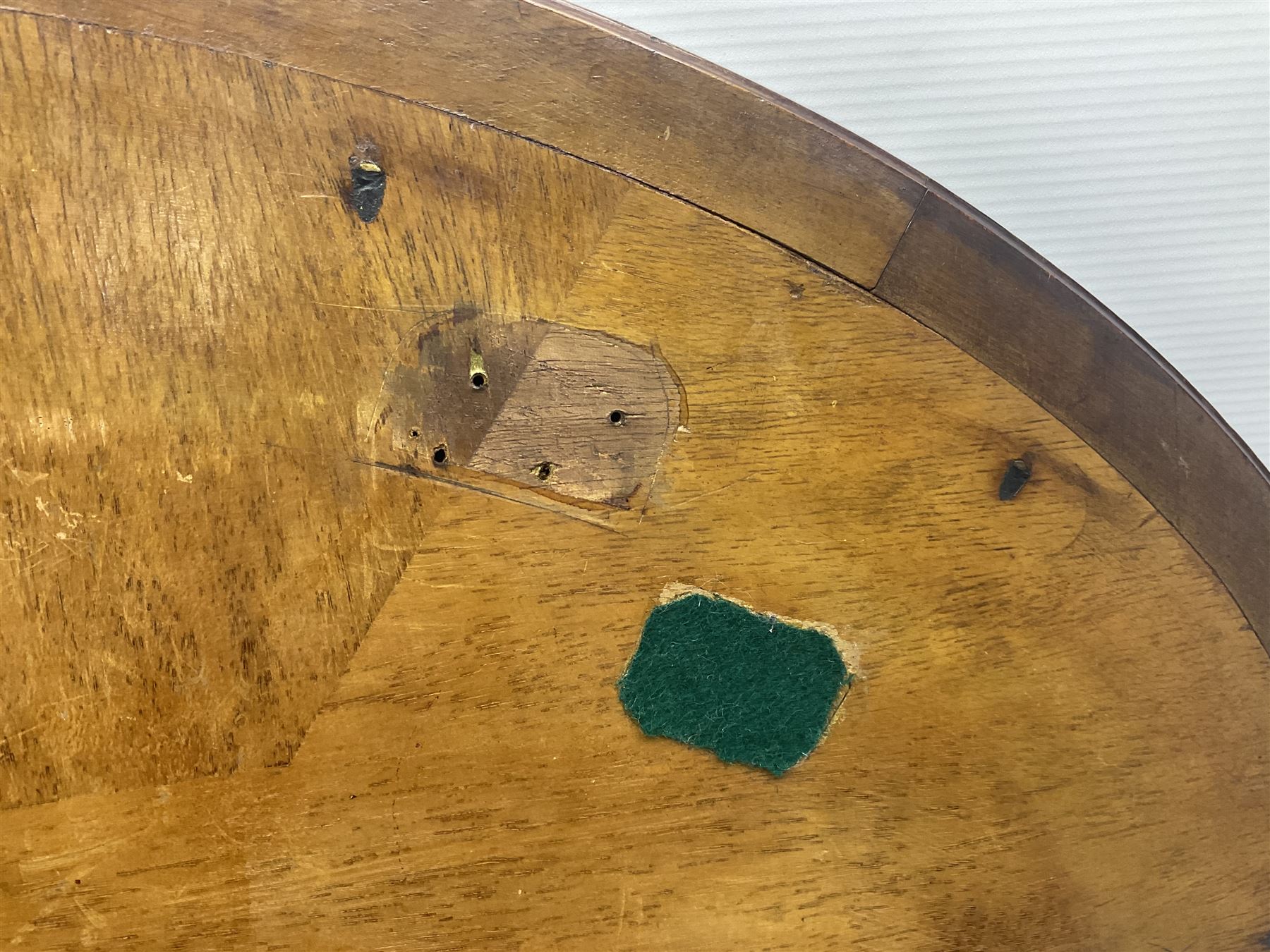 Late 19th/early 20th century mahogany and marquetry inlaid tray, of oval form with twin scrolled handles and moulded border, the central panel inlaid with figures seated at a table drinking tea, L99cm