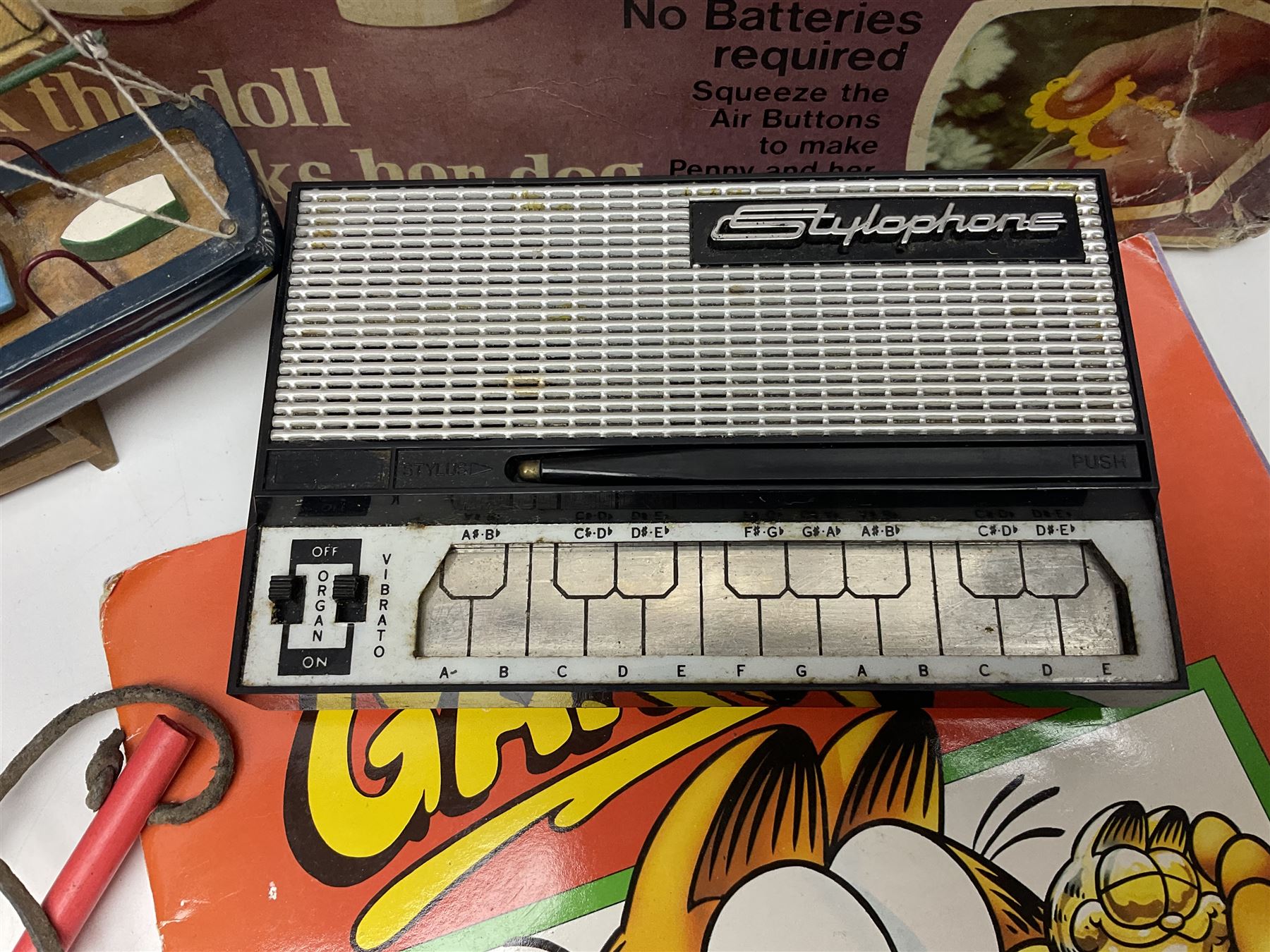 Two boxed Bradgate Penny Puppywalker dolls; Garfield soft toy and Panini sticker album; boxed Stylophone with instructional 45rpm record; and other toys