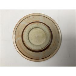 Studio pottery bowl, probably by Svend Bayer of Wenford Bridge, the stoneware body of shallow circular footed form with brushwork decoration of a stylised bird figure in grey upon peach ground within bands of iron red, unmarked, D18.5cm