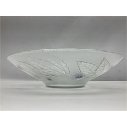 Two French pressed glass bowls of shallow circular form, relief moulded with flowers and foliage, together with a matching charger, largest bowl D34cm  