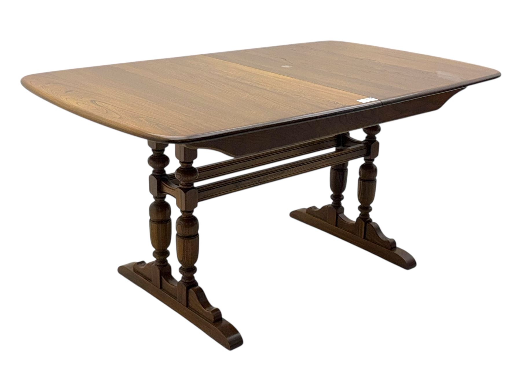 Ercol - late 20th century oak refectory dining table, rectangular top with rounded corners and central extending leaf, raised on turned baluster supports united by a stretcher (Extended 200cm)