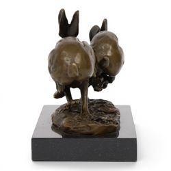 Bronze figure group, modelled two hares in chase, upon naturalistically modelled oval base signed Nick and with foundry mark, raised upon black marble base, H11cm L12.5cm