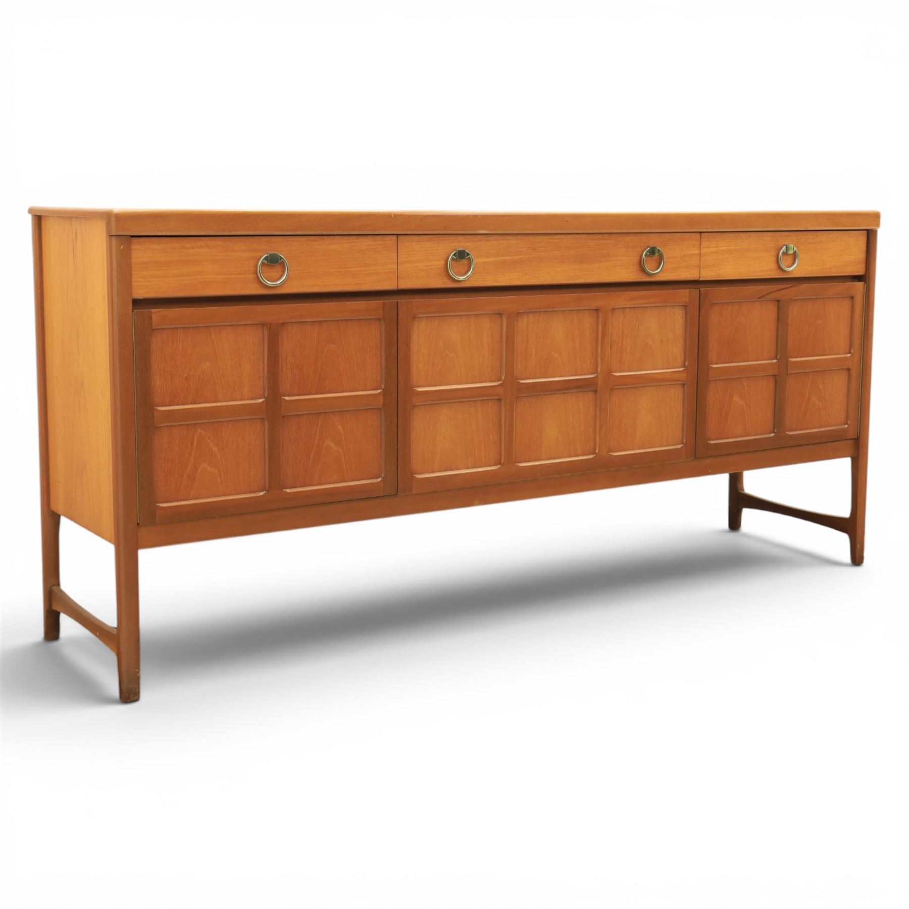 Nathan - 'Squares' mid 20th century teak sideboard, fitted with three drawers with brass ring handles, above a central fall front cabinet, flanked by two cupboard doors, raised on square tapering supports