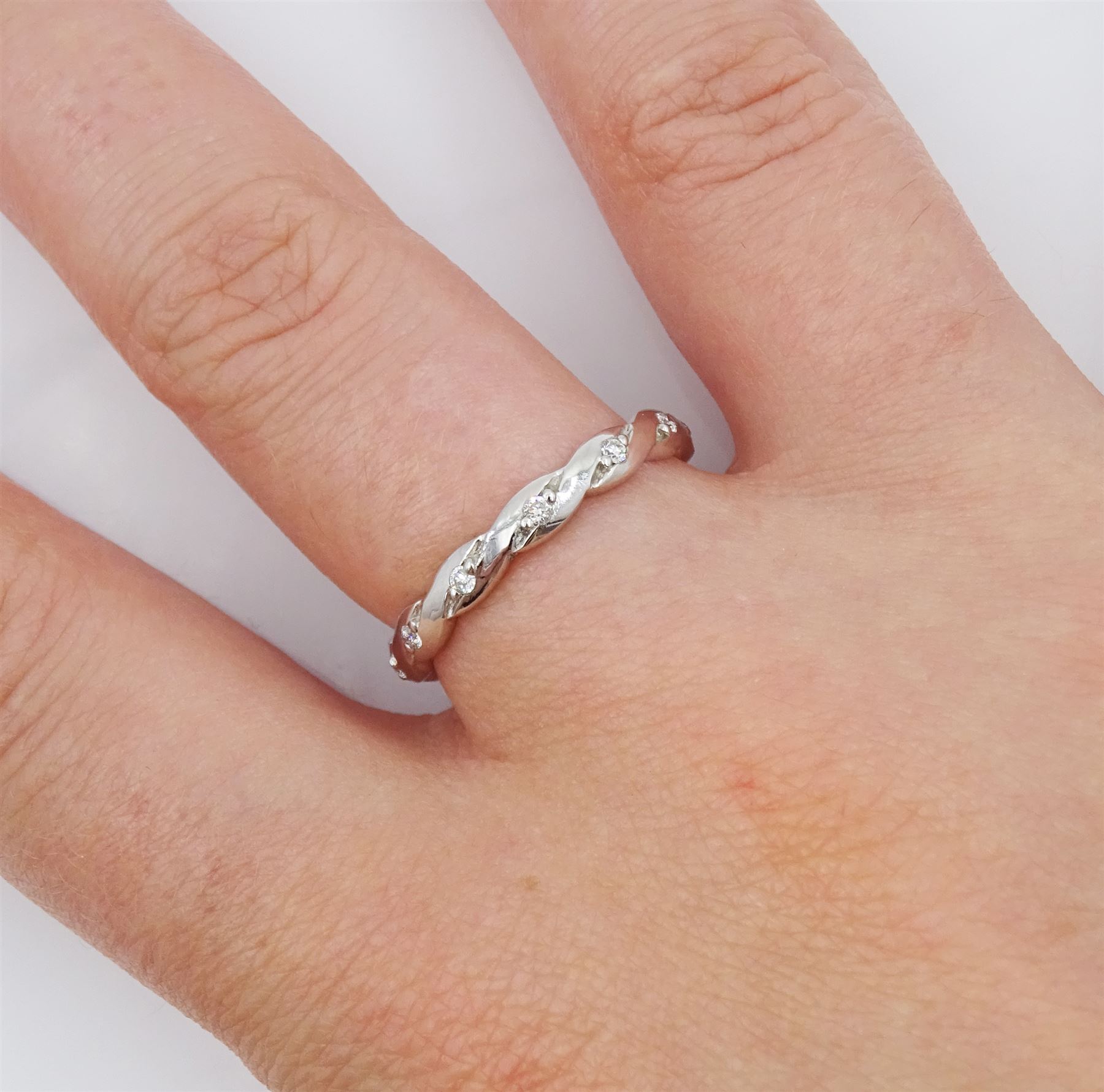 18ct white gold diamond full eternity ring, crossover set with twelve round brilliant cut diamonds, hallmarked