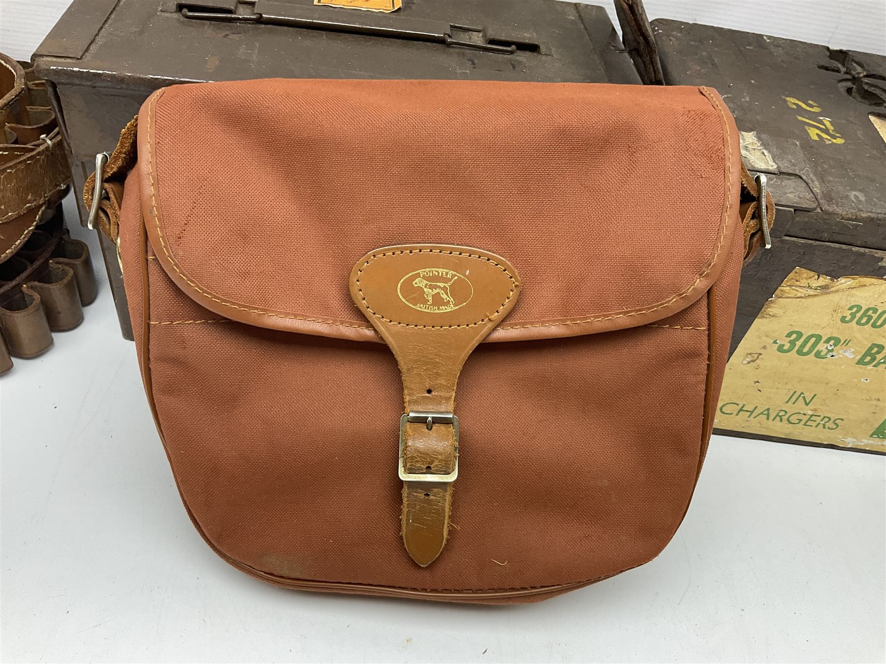 Miscellaneous shooting accessories - W.J. Bowman & Sons clay pigeon launcher; two leather cartridge belts; three cartridge bags; two canvas/leather game bags; and two metal/wooden cartridge boxes