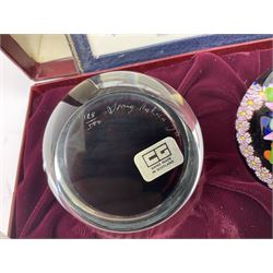 Set of four Caithness paperweights titled Four Seasons, in presentation box with certificate, designed by Colin Terris and made by William Mason, each internally decorated with a seasonal flower within a millefiori cane work garland, numbered 128 of 500
