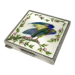 Silver and enamel compact, of square form with engine turned decoration to the sides and back, the hinged cover with inset enamel panel depicting an exotic bird within a surround of trailing vines, opening to reveal a mirror beneath, hallmarked Henry Clifford Davis, Birmingham 1950, 7.5cm x 7.5cm