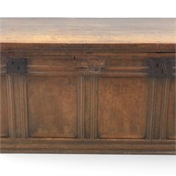 Large 17th century oak coffer, plank top with moulded edge, four panel front with channel moulded uprights, retaining original wrought iron strap hinges and central lock plate, panelled ends, raised on stile supports