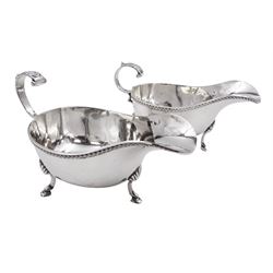 Pair of modern silver sauce boats, of typical plain form, each with oblique gadrooned rims and chevron capped flying scroll handles, upon three hoof feet, hallmarked Charles S Green & Co Ltd, Birmingham 1961