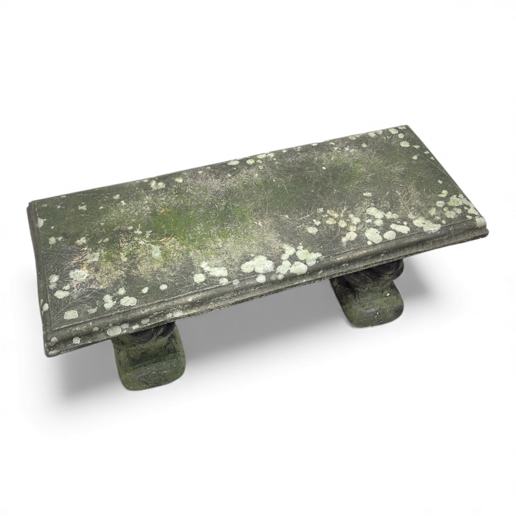 Weathered cast-stone garden bench with squirrel designed supports and rectangular top