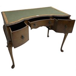Early 20th century Queen Anne design walnut writing desk, reverse bow-front with inset green leather writing surface and foliate carved edge, fitted with three drawers, raised on cabriole supports
