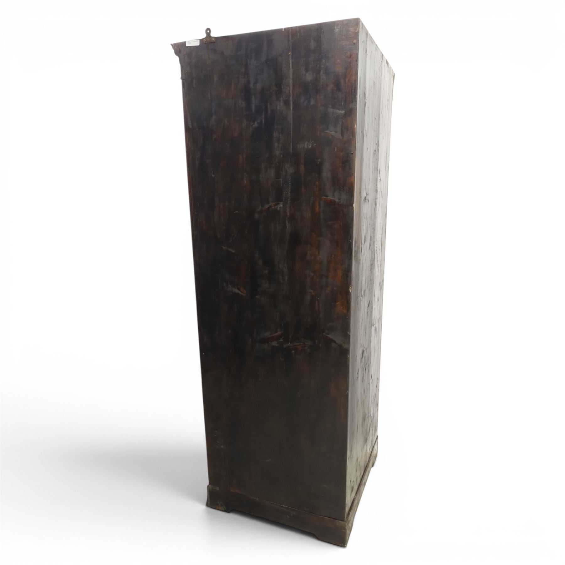 Edwardian inlaid mahogany cylindrical corner hall-robe, projecting cornice, figured veneer and crossbanded door, enclosing hanging hooks and shelf, raised on a plinth base with bracket feet