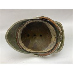 Early 20th century French mounted gendarme's helmet, brass with nickel-silver mountings, broad band embossed with fused grenade, high comb with the face of the gorgon Medusa at the peak and with a black horse hair crest, plume socket at the left, leather-backed nickel-silver chin scales with lion mask mounts.