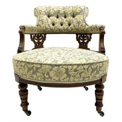 Edwardian walnut three piece drawing room salon suite - pair tub shaped occasional chairs and nursing chair, upholstered in cream and pale blue fabric decorated with floral pattern, pierced and foliate carved splats, curved sprung seats, the nursing chair with buttoned back rest, turned supports with brass and ceramic castors, recently reupholstered by Peter Silk of Helmsley