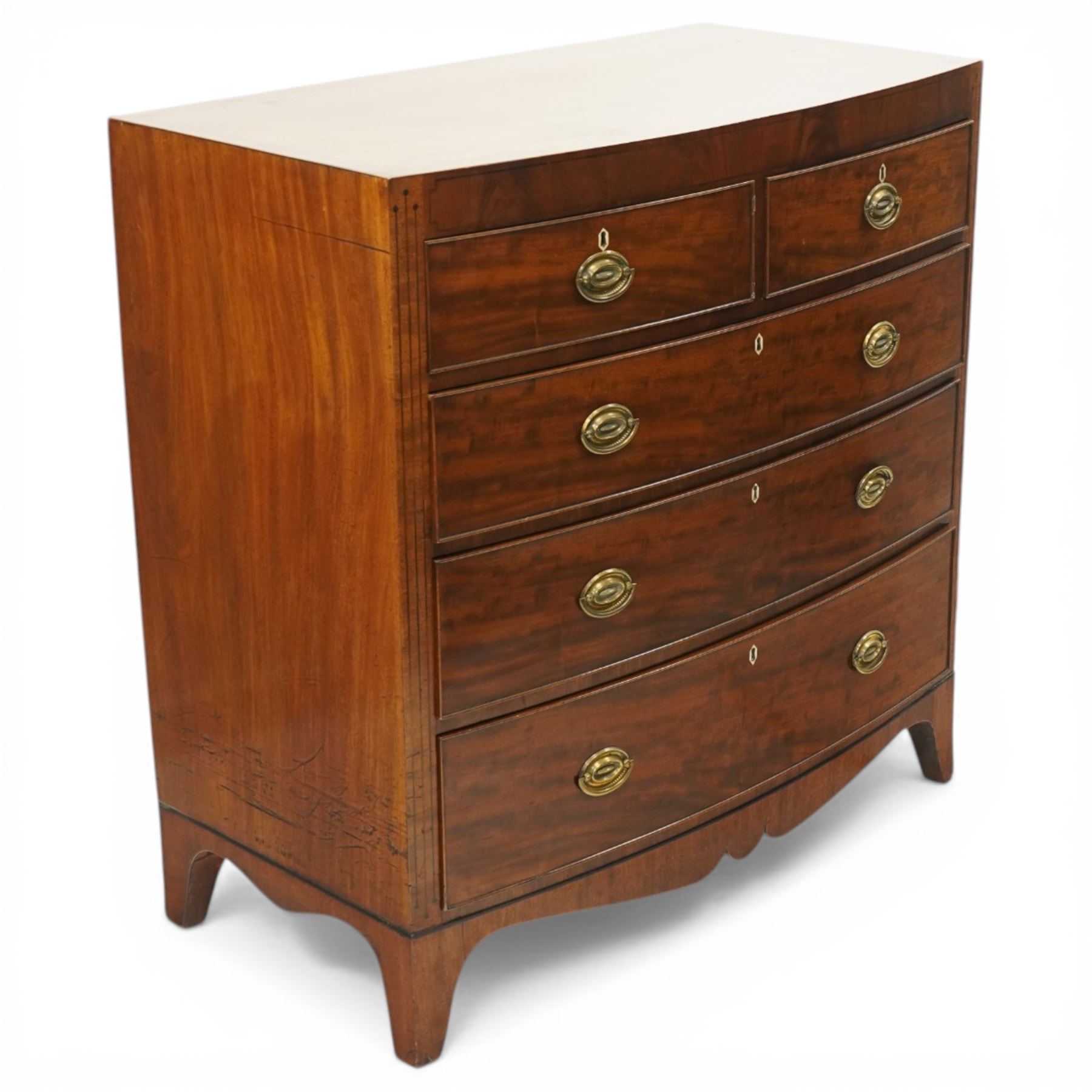 Early 19th century Regency mahogany bow-front chest, with banded caddy top and ebony stringing, fitted with two short over three long cockbeaded drawers, with oval brass handles, shaped apron and splayed bracket feet