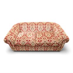Tetrad - grande two seat 'Elgar' sofa of traditional Chesterfield shape with rolled arms, upholstered in red and gold foliate patterned fabric with matching loose and scatter cushions, on compressed bun feet