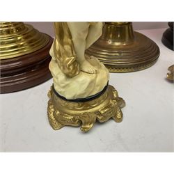 Victorian cast brass oil lamp, with fluted pink glass shade, together with two smaller brass oil lamps with pink shades and reservoirs and a pair of oil lamps, the bases modelled as putti, with pink glass reservoir  and frosted shades, tallest H70cm