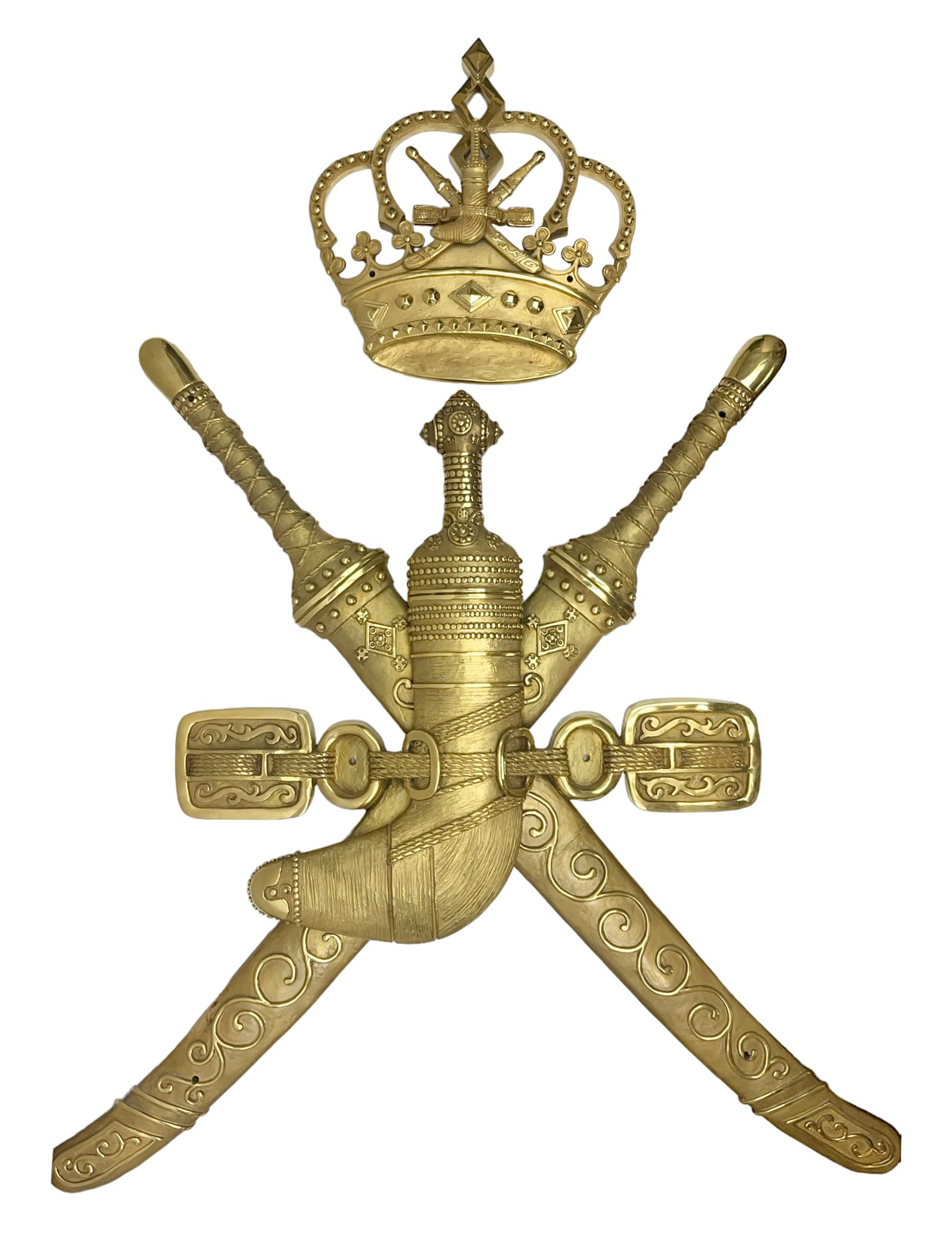 Gilt state emblem for Oman, a sheathed khanjar dagger superimposed above pair of crossed swords and belt and a seperate crown, main emblem H84cm, W83cm, crown H35cm, W33cm
Provenance by vendor repute: The emblem was previous mounted above HM's throne, in the main majalis, of the HM Royal Yacht AL Said, until 1985 when HM Sultan Qaboos ordered the upgrading of all state emblems, The emblem was gifted to the vendor who worked for the Sultans Royal Yacht Squadron
