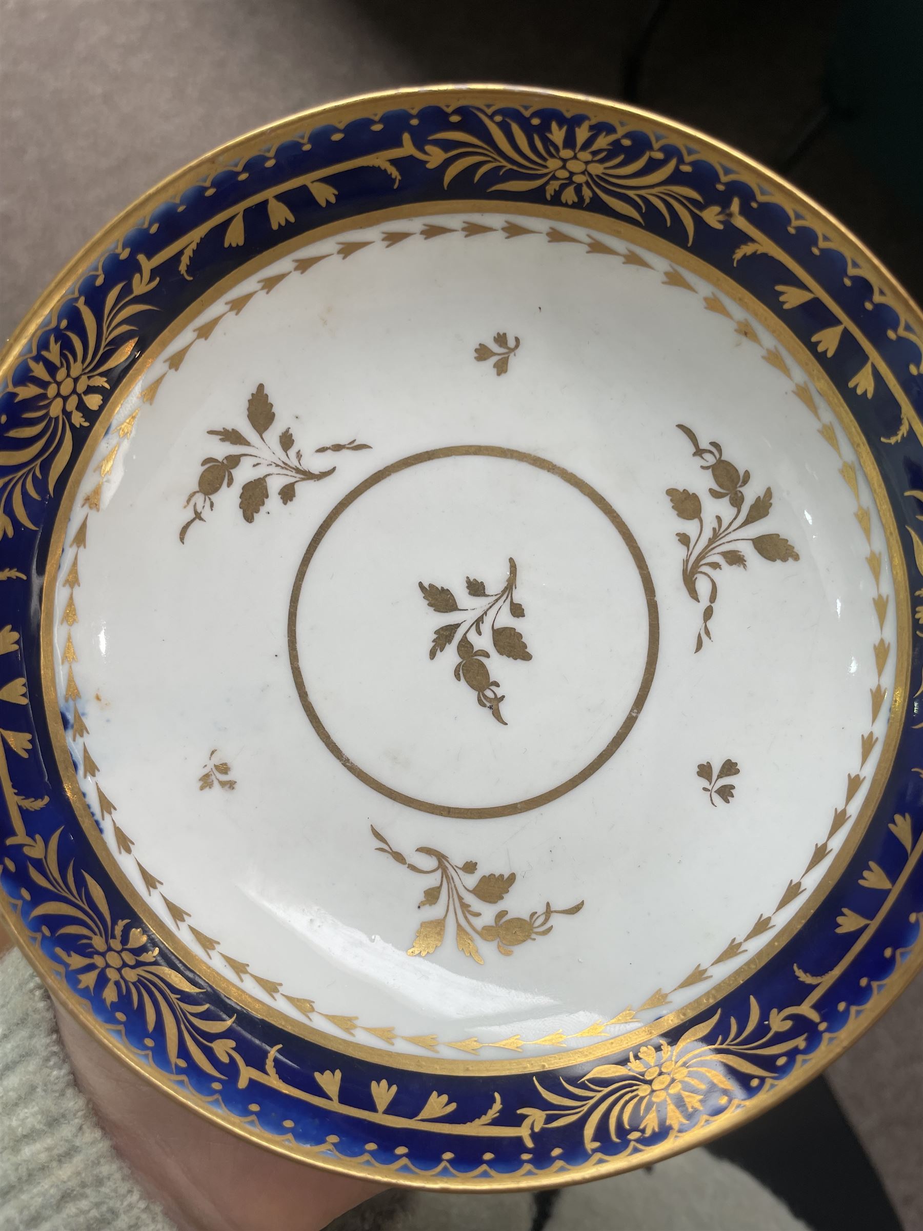  19th century Coalport Felt Spar porcelain cup and saucer painted with panels of flowers on a green and gilt ground and marked I Rose & Co and an early 19th century Worcester trio decorated in blue and gilt, Pattern No.274 