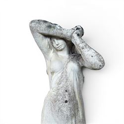 Weathered cast stone garden statue of a 'Shy Maiden', raised on square plinth base