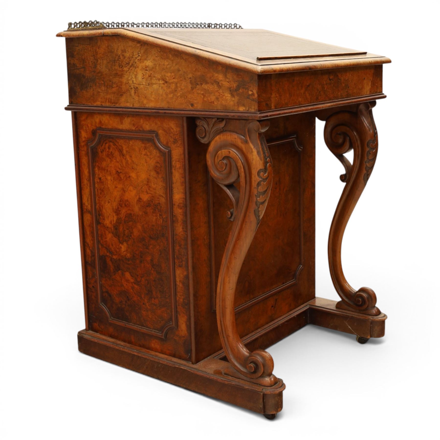 Victorian figured walnut Davenport, the fixed fall with drawer to the side enclosing writing compartment, green tooled leather writing inset, galleried back rail, right side fitted with four drawers behind a panel, opposing panelled side, raised on carved cabriole front supports with scroll terminals and platform base
