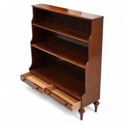 Mahogany waterfall bookcase, fitted with two fixed shelves over two drawers, the drawers with satinwood bands and turned handles, on turned tapering feet 