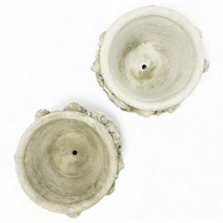 Pair of modern cast stone garden planters, circular tapering bodies moulded with cherubs in high relief among foliage and fruiting vines, in a weathered stone finish