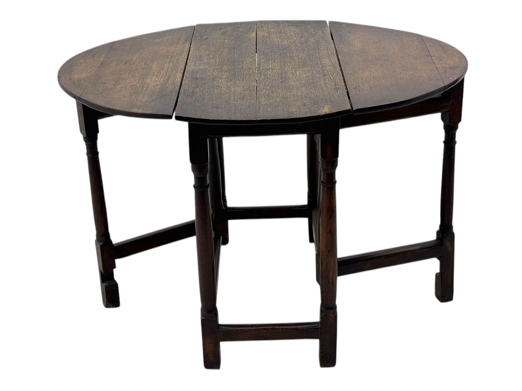 19th century oak gateleg table, the oval drop-leaf top formed of four planks, on turned column supports united by rectangular stretchers