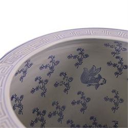 20th century blue and white fishbowl planter, decorated with birds in blossoming branches, internally decorated with goldfish, upon a wooden base, H44cm