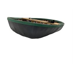 Coracle boat, comprised of woven planks and waterproof covering with single plank seat and strap