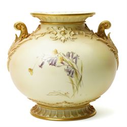 Late Victorian Royal Worcester vase of baluster design with gilt handles and painted with flowers on a blush ivory ground H22cm, date code for 1892