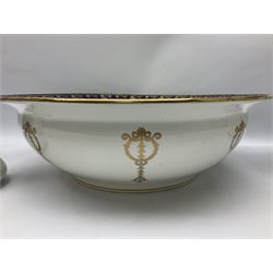 Early 20th century Bishop and Stonier four piece toilet set, comprising washbowl, wash jug, toothbrush pot, and chamber pot, each  decorated with deep blue band and husk swags and festoons in gilt, with printed Caduceus Bisto marks beneath and printed retailers mark 'Manufactured for Harrods Limited London', wash bowl D43cm, wash jug H31.5cm