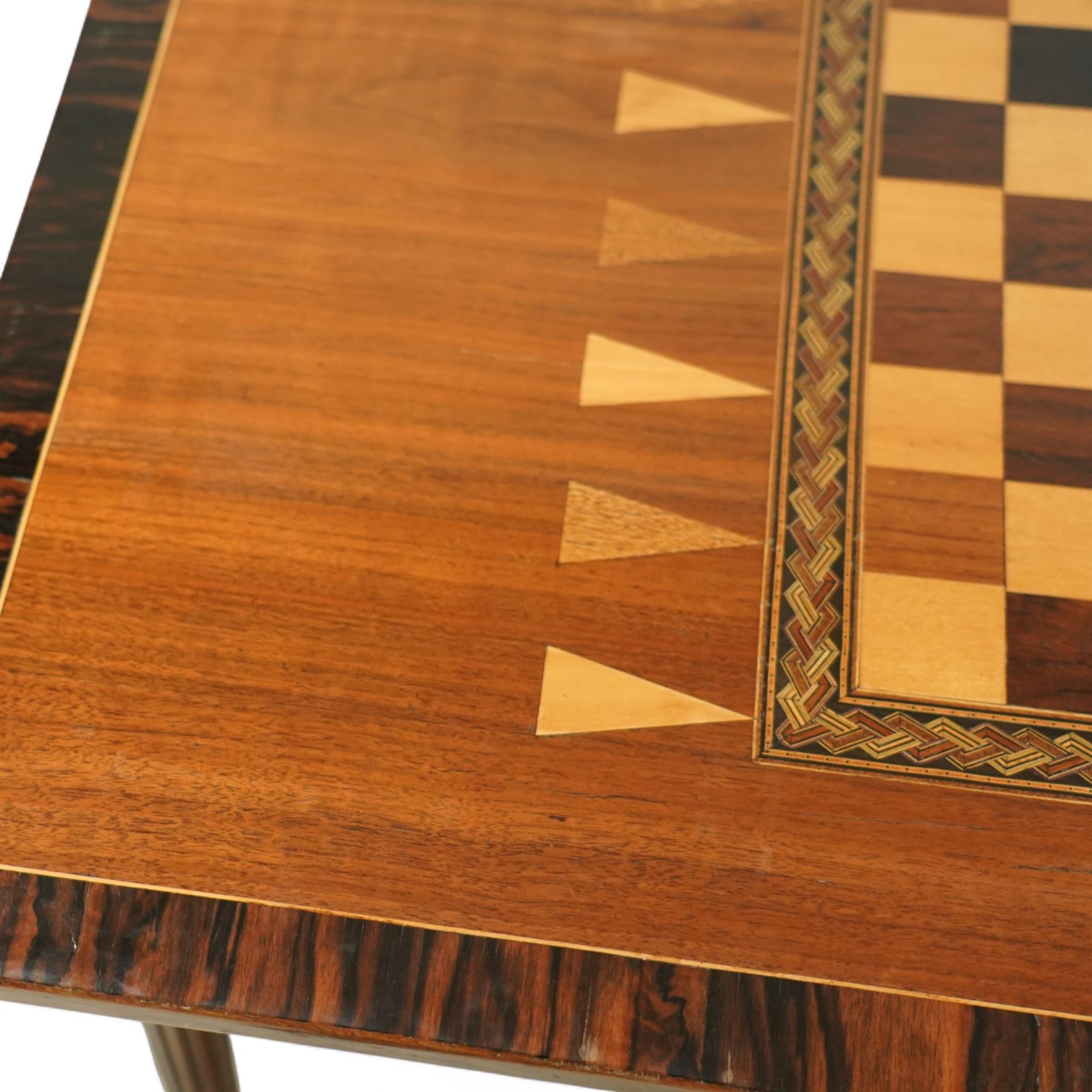 19th century mahogany fold-over card table, the crossbanded rectangular top opening to reveal an inlaid games centre with chessboard and backgammon designs, raised on turned and reeded legs with extending rear supports