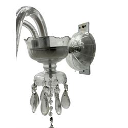 Pair of cut glass two branch wall sconce candelabras, each with S scroll extending branches with shaped and bevelled circular drip trays, hung with pendant drops