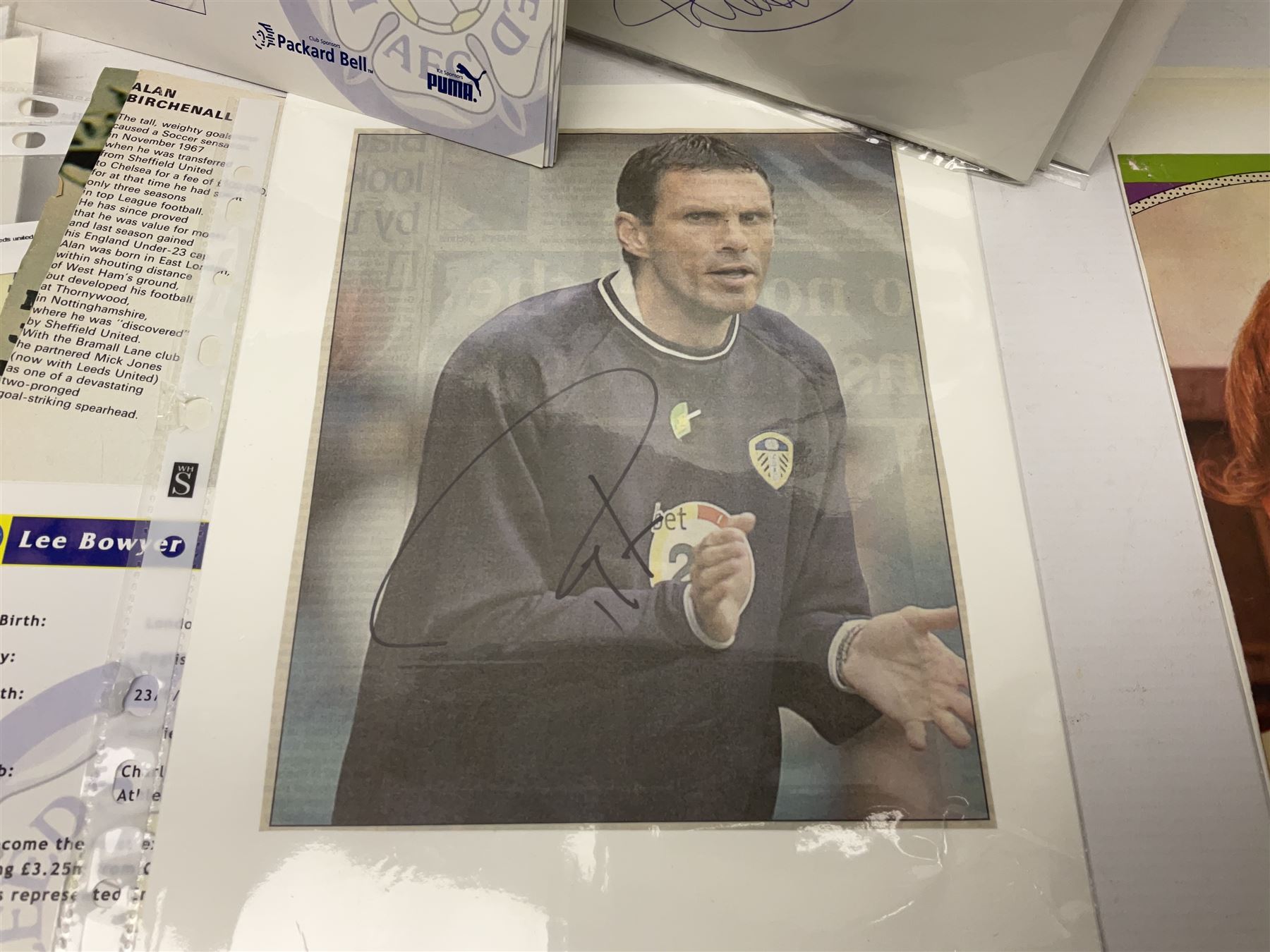 Collection of approximately 200 Leeds United related autographs, predominantly signed newspaper cuttings, contained within ring binder, together with a number of loose examples