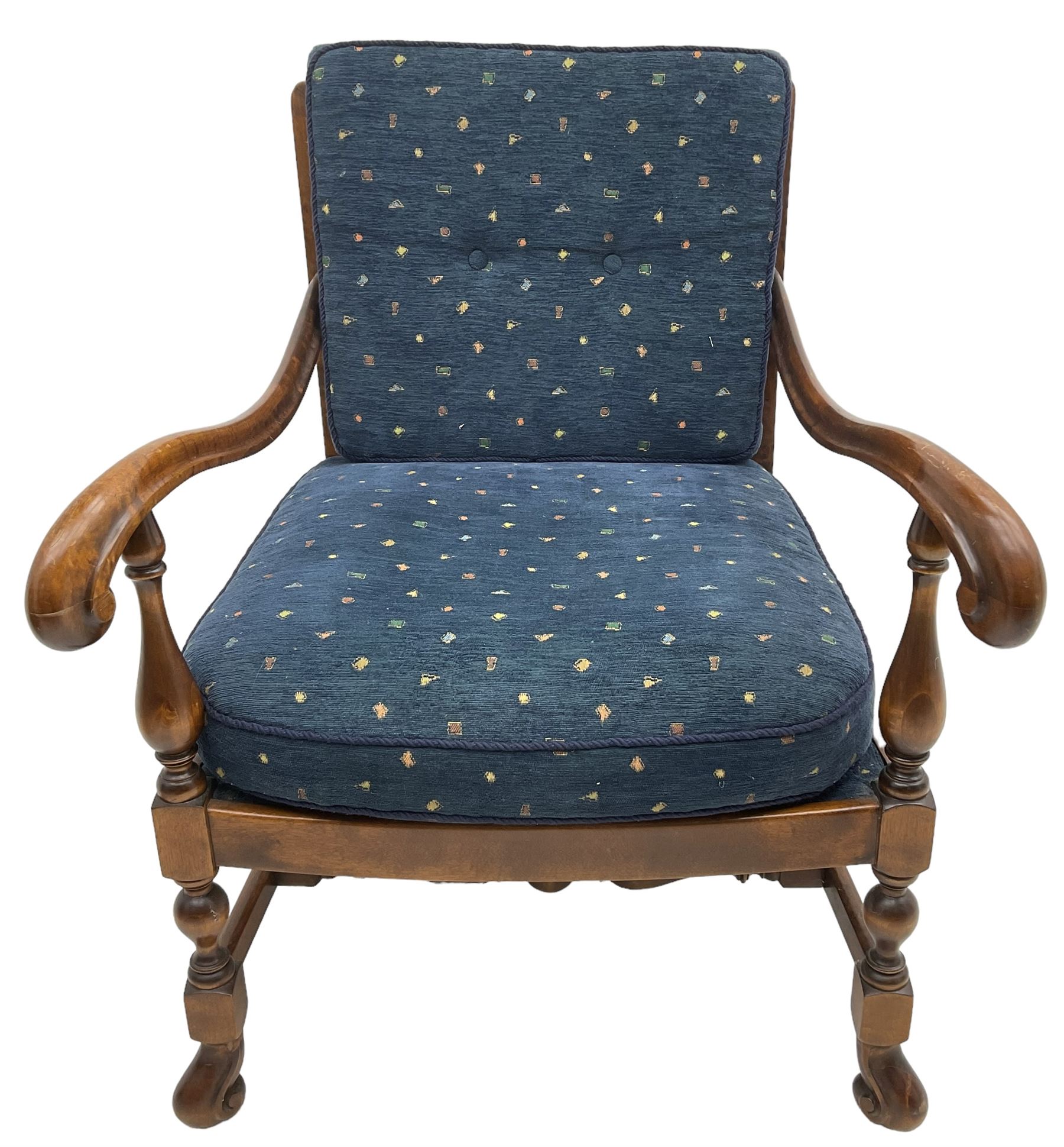 Early 20th century stained beech framed armchair, cane panel back over scrolled arm terminals, raised on turned supports united by turned H-stretcher, with patterned blue upholstered loose back and seat cushions
