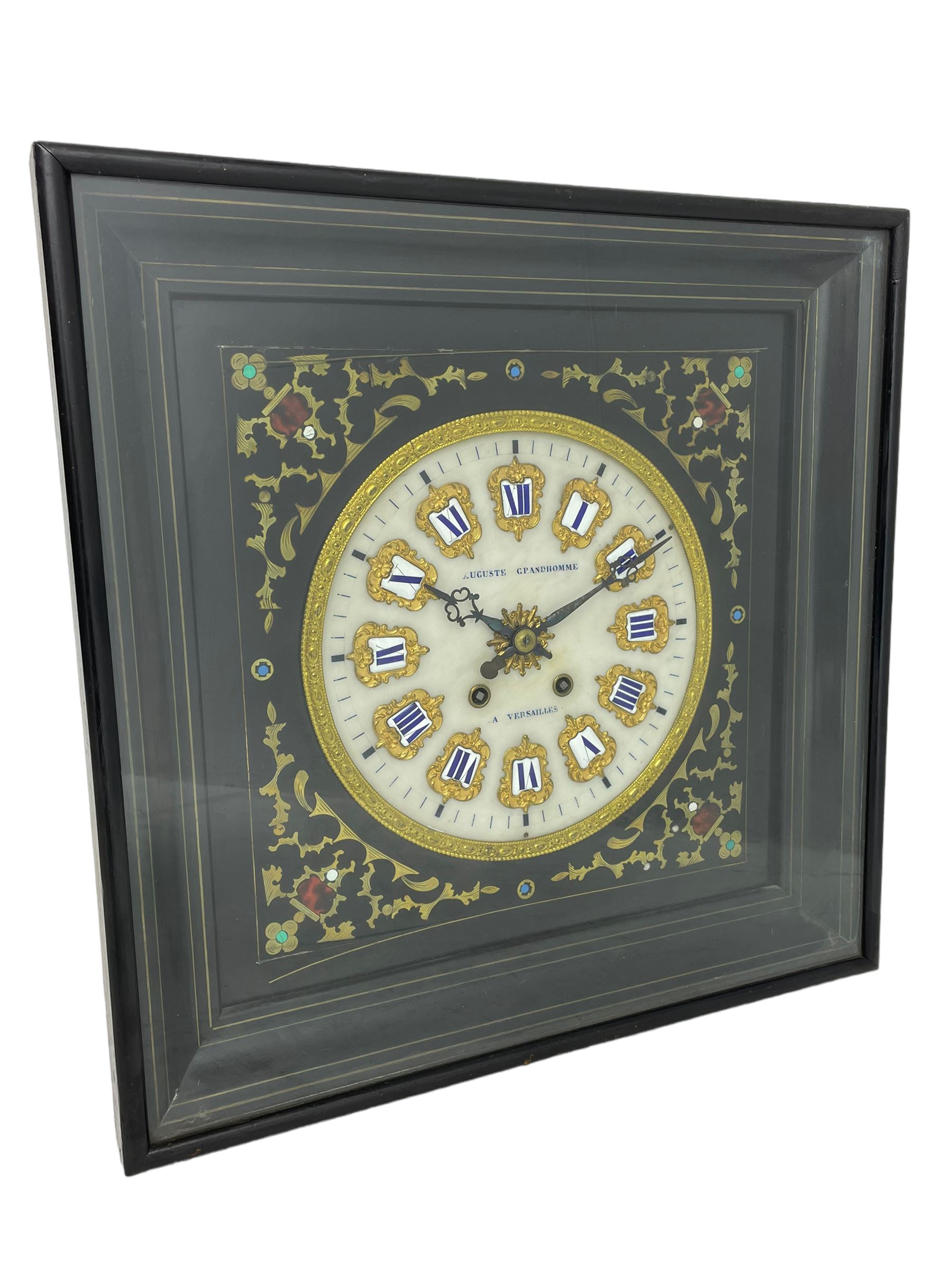 Auguste GP. Andhomme - French vineyard clock,  late 19th century 8-day twin train spring driven wall clock with enamelled and inlaid brass decoration within an ebonised and glazed case, circular enamel dial with cartouche Roman numerals, minute markers, pieced steel hands and a chased brass slip, striking movement, sounding the hours and half hours on a coiled gong. With pendulum and key.  
